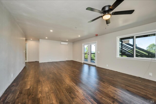 spare room featuring ceiling fan, french doors, and dark hardwood / wood-style floors