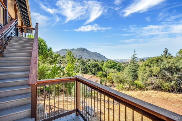 wooden terrace with stairway and a mountain view