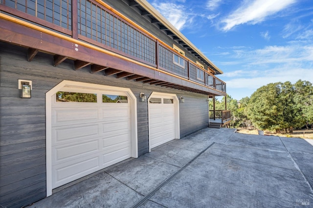 garage featuring concrete driveway