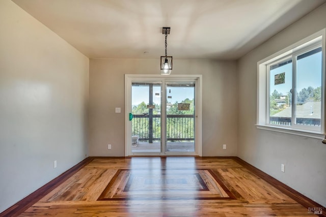 interior space featuring baseboards and wood finished floors