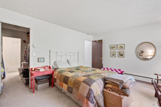 bedroom with a textured ceiling, light colored carpet, and a baseboard heating unit