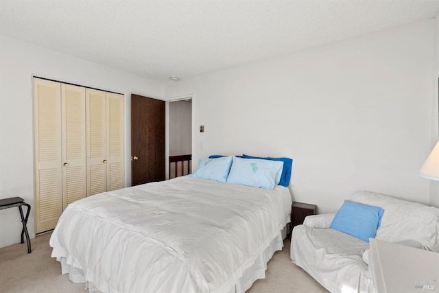 bedroom with light colored carpet and a closet