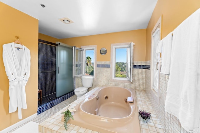 bathroom featuring tile patterned flooring, toilet, and independent shower and bath