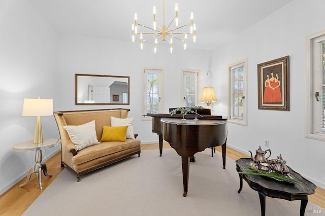 sitting room featuring an inviting chandelier and hardwood / wood-style flooring