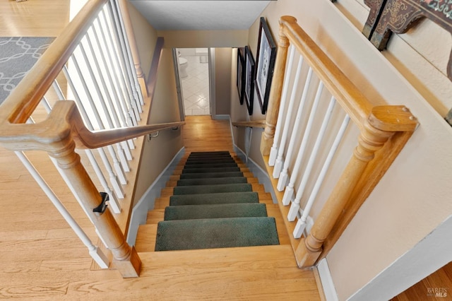 staircase featuring hardwood / wood-style flooring