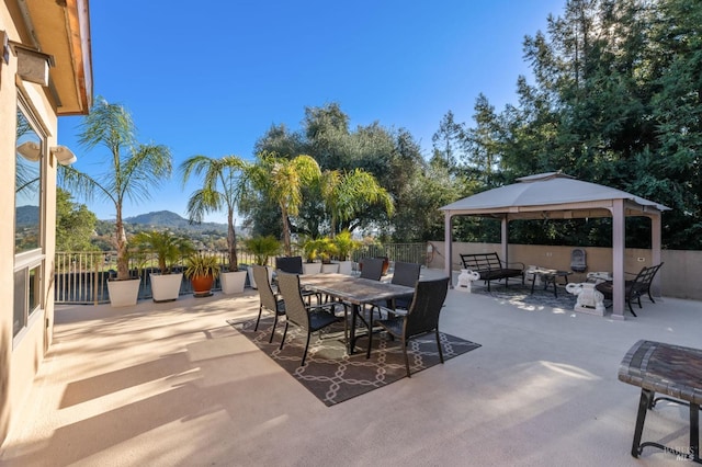 view of patio featuring a gazebo and a mountain view