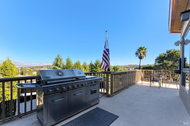 view of patio / terrace featuring a mountain view and a grill