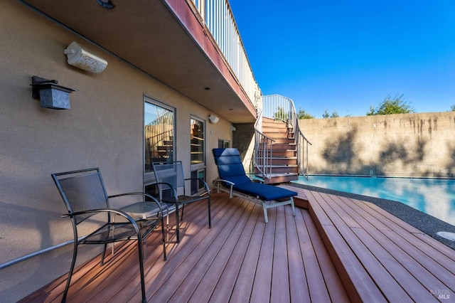 deck with a fenced in pool