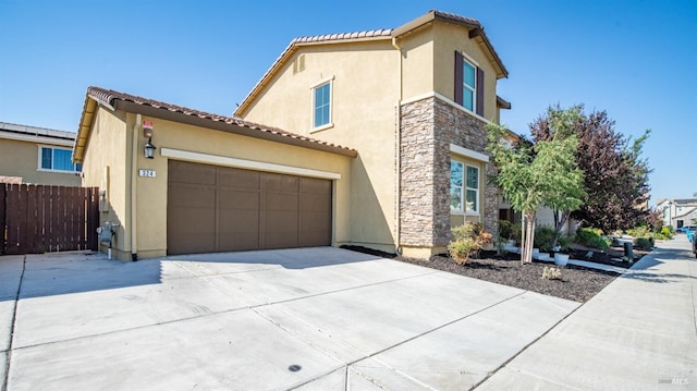 mediterranean / spanish home featuring a garage