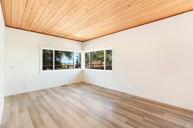 spare room featuring ornamental molding, wood ceiling, and light wood-type flooring