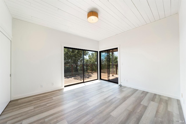 empty room with light wood-type flooring and wooden ceiling