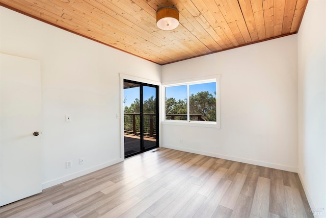 spare room featuring light wood-type flooring, ornamental molding, and wood ceiling