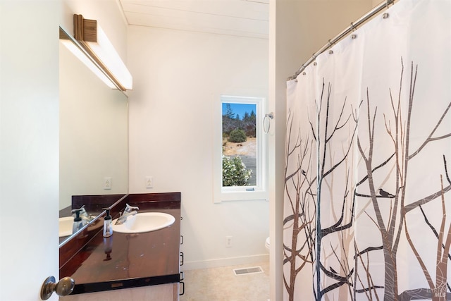 bathroom featuring vanity and toilet