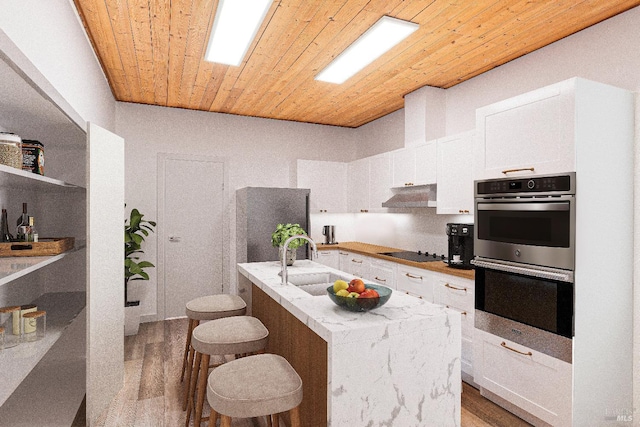 kitchen with sink, stainless steel double oven, wood ceiling, a kitchen island with sink, and exhaust hood