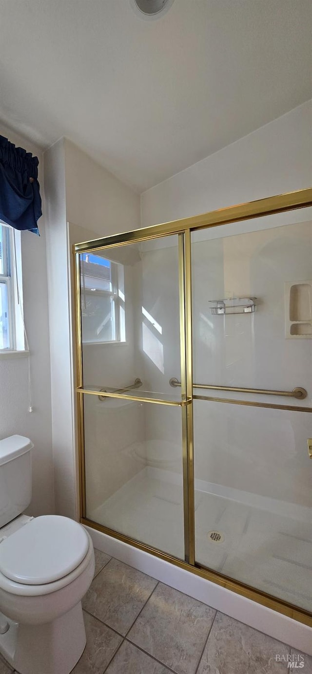 bathroom with tile patterned flooring, an enclosed shower, and toilet