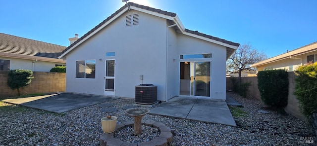 rear view of property featuring a patio area and central AC