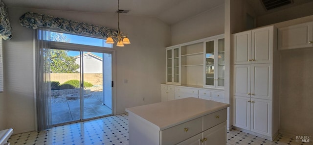 doorway with lofted ceiling and a notable chandelier