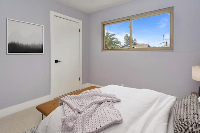 carpeted bedroom with baseboards