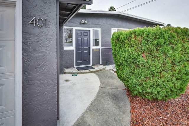 doorway to property with stucco siding