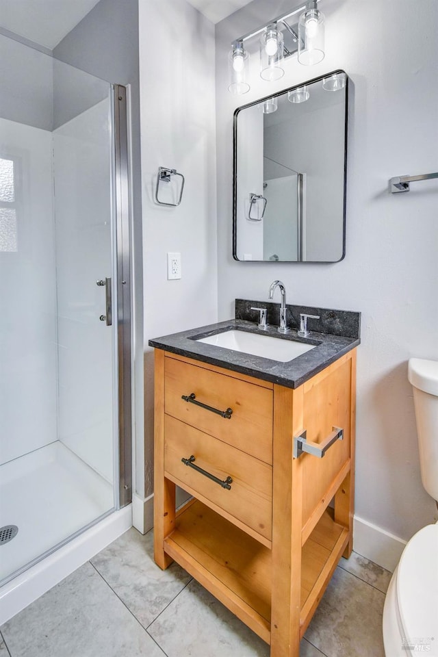 full bathroom with toilet, a shower stall, vanity, baseboards, and tile patterned floors