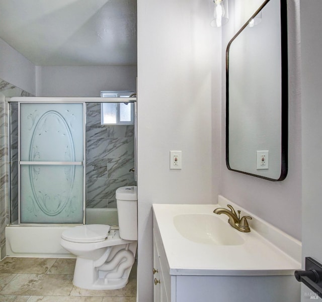 bathroom with vanity, toilet, and bath / shower combo with glass door