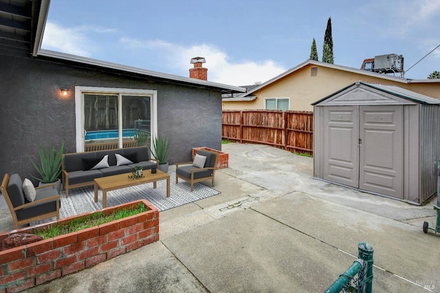 view of patio with fence, a storage unit, outdoor lounge area, and an outdoor structure