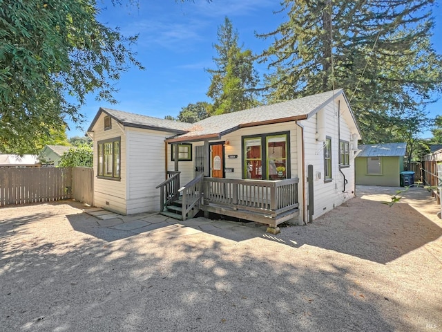 view of front facade featuring a deck and french doors