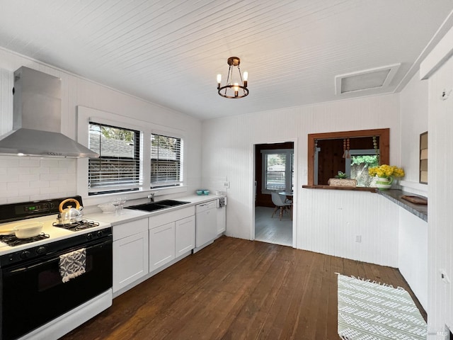 kitchen with white appliances, sink, wall chimney exhaust hood, dark hardwood / wood-style floors, and white cabinetry