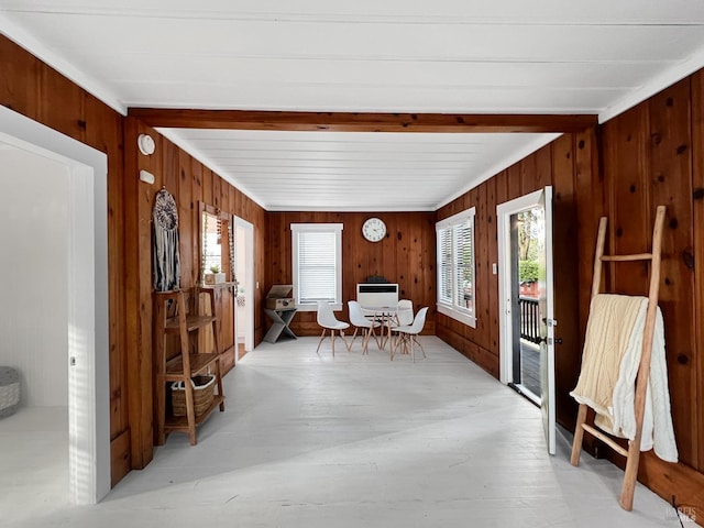 unfurnished sunroom featuring beam ceiling and heating unit