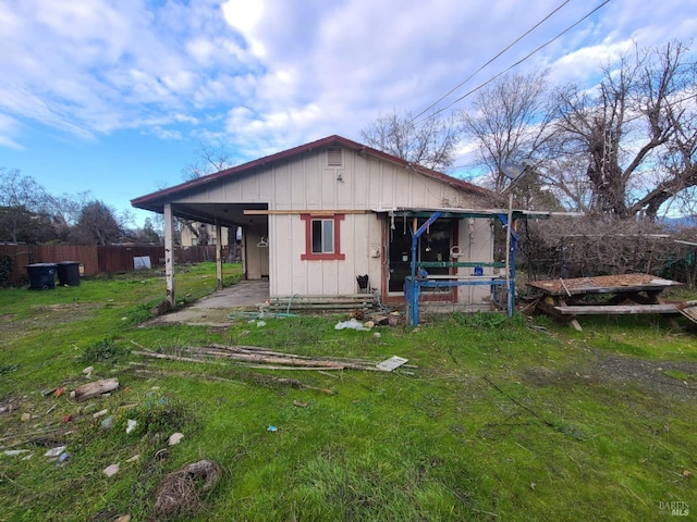 rear view of property with an outbuilding