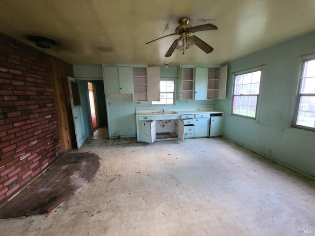 kitchen with sink, a wealth of natural light, and ceiling fan