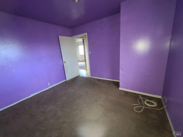 unfurnished room featuring concrete flooring