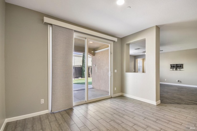 unfurnished room featuring ceiling fan and light hardwood / wood-style floors