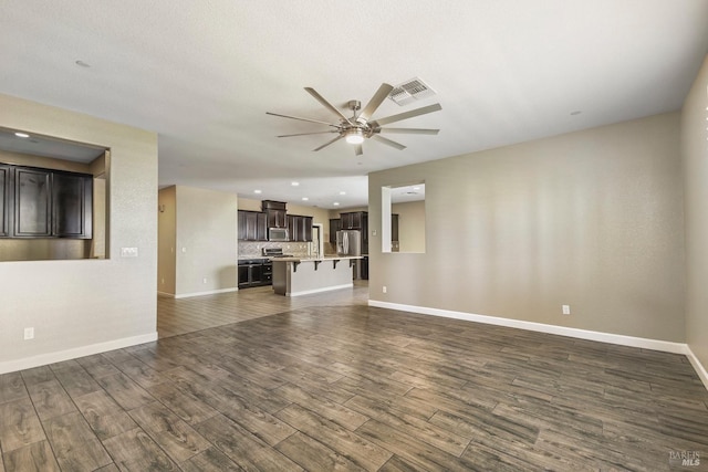 unfurnished living room featuring ceiling fan