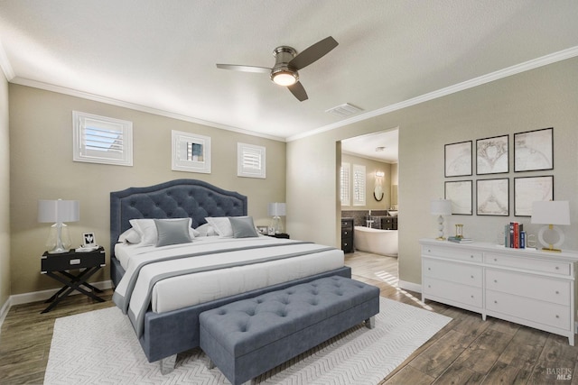 bedroom with hardwood / wood-style floors, ensuite bathroom, ceiling fan, and crown molding