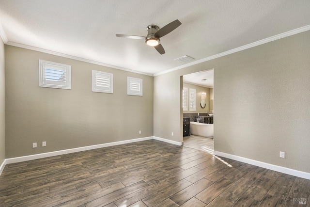 spare room featuring dark hardwood / wood-style flooring, ceiling fan, and ornamental molding