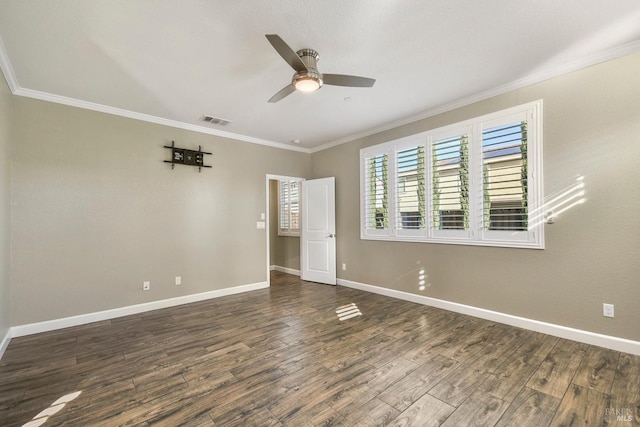 empty room featuring dark wood-type flooring, ceiling fan, and ornamental molding