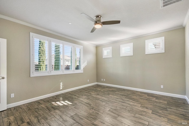 empty room with ceiling fan, crown molding, and hardwood / wood-style flooring