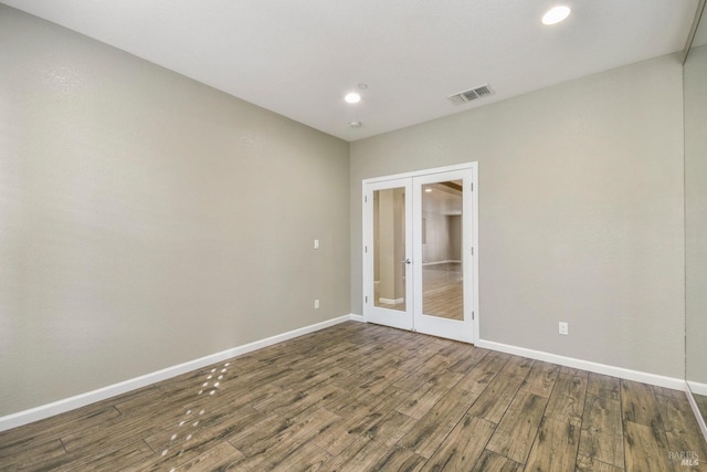 unfurnished room with french doors and hardwood / wood-style flooring