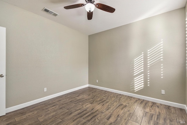 spare room featuring ceiling fan and dark hardwood / wood-style flooring