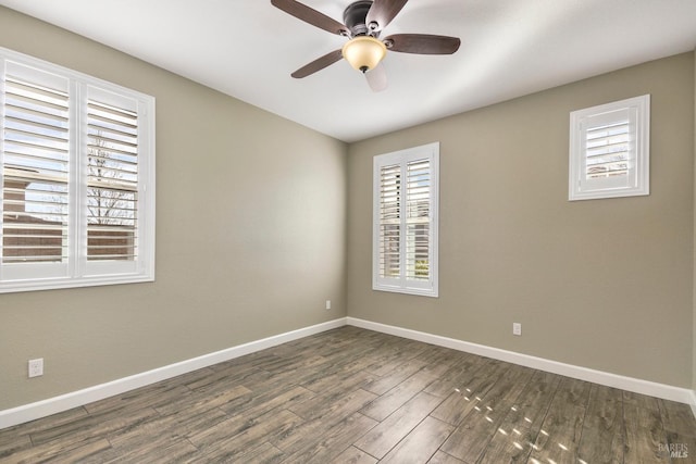 spare room featuring dark hardwood / wood-style floors and ceiling fan