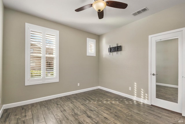 unfurnished room featuring dark hardwood / wood-style floors and ceiling fan