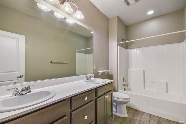 full bathroom featuring shower / bathing tub combination, vanity, and toilet