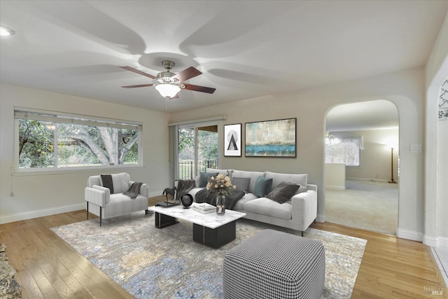 living room with ceiling fan and light wood-type flooring