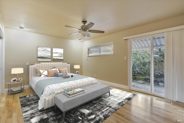 bedroom featuring ceiling fan, wood-type flooring, and access to outside