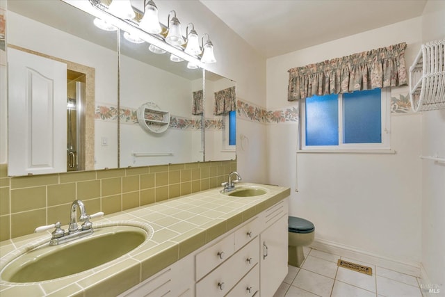 bathroom featuring backsplash, tile patterned flooring, vanity, and toilet