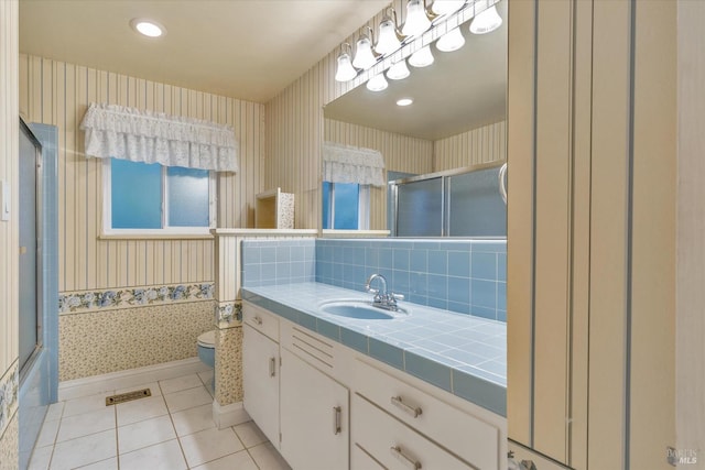 bathroom featuring tile patterned floors, tasteful backsplash, vanity, and toilet