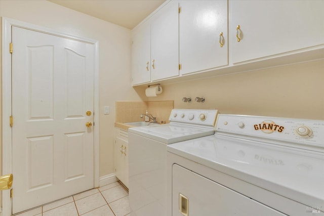 washroom featuring cabinets, light tile patterned floors, separate washer and dryer, and sink