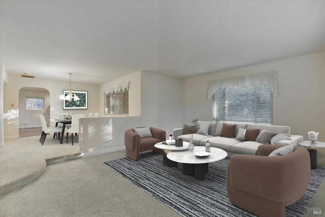 living room featuring a chandelier, carpet floors, and plenty of natural light