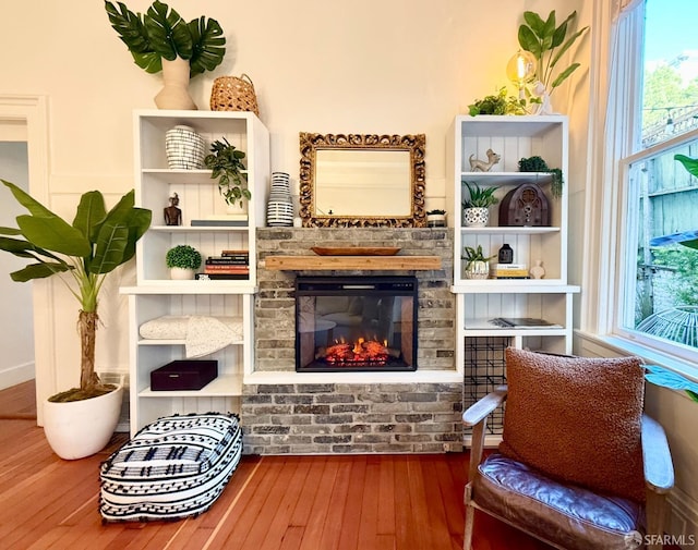 living area featuring a fireplace and wood finished floors